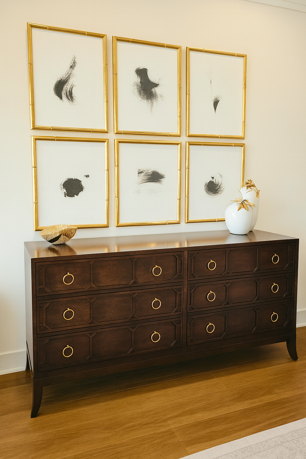 Dark dresser with six gold-framed abstract artworks